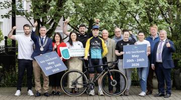 Group standing with bike and cyclist