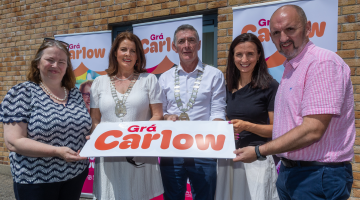 People Holding a Gra Carlow Sign