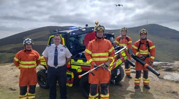 Firemen standing at vehicle