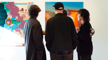 PEOPLE LOOKING AT ART WORK