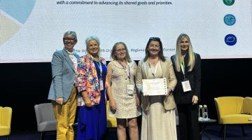 Group standing with certificate