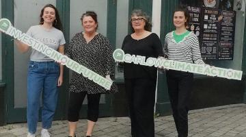 4 Women holding signs